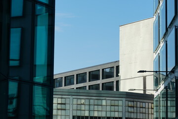 a scene from a business space, several corporate buildings standing near to each other with their facades of glass, marble, chrome and concrete, closed due to lockdown of coronavirus, covid-19