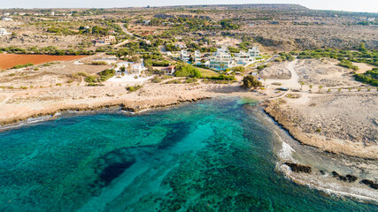 Aerial bird's eye view of Ammos tou Kambouri beach, Ayia Napa, Cavo Greco, Famagusta, Cyprus. Tourist attraction bay, rocky beach with golden sand, sunbeds, sea restaurant in Agia Napa from above.