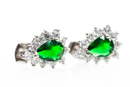 Silver Earrings With Green Emerald Stones Close Up Macro Shot On White.