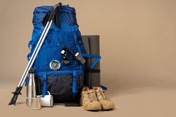 Blue backpack and hiking boots. Mountain gear close up - obrazy, fototapety, plakaty
