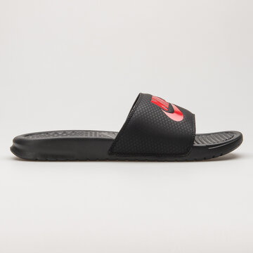 VIENNA, AUSTRIA - JUNE 14, 2018: Nike Benassi JDI black and red sandal on white background.