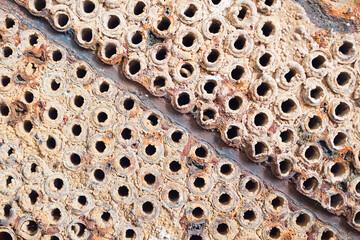 Tube sheet or plate of heat exchanger or boiler closeup texture macro diagonal background full of...