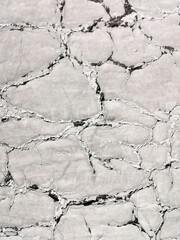 Texture of white paint on a gray background. Volume relief retro.