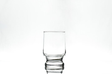Empty glass on white background. Isolated. Backlight.
