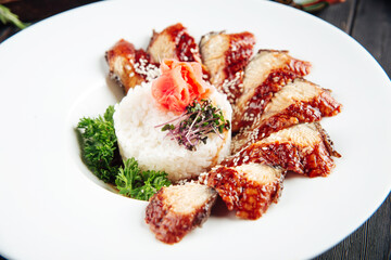 Cooked eel fish rice, greens and marinated ginger 