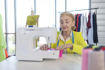 Senior female designers are sewing clothes with sewing machines. As an extra income at retirement