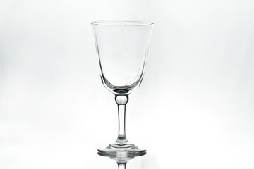 Empty wineglass on white background. Isolated. Backlight.