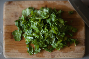 Chopped coriander on wood chopping board