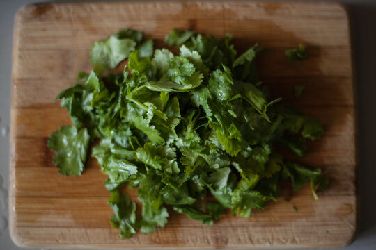 Chopped Coriander On Wood Chopping Board