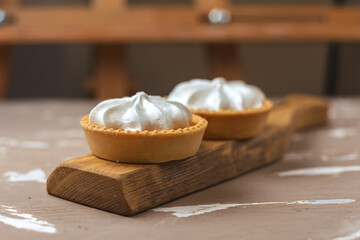 Lemon tart. Two cakes on a wooden plate