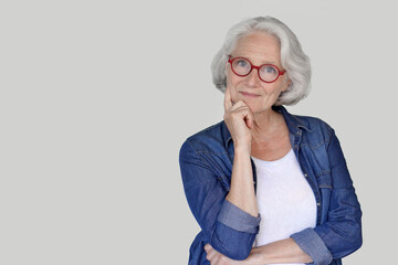 Portrait of senior woman wearing blue jeans shirt, isolated