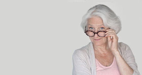 Portrait of senior woman with red eyeglasses, isolated