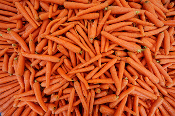 Background texture of carrots. Fresh organic carrots in the supermarket.