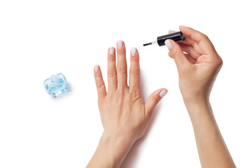 Female hands apply oil to nails. Cuticle oil. Isolated on a white background. View from above