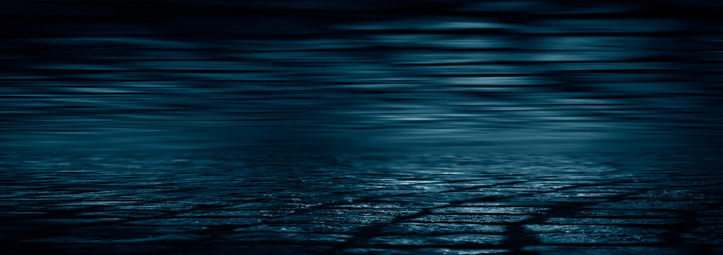 Dark street, wet asphalt, reflections of rays in the water. Abstract dark blue background, smoke, smog. Empty dark scene, neon light, spotlights. Concrete floor