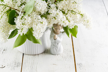 White lilac flowers on wooden table