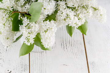 White lilac flowers on wooden table