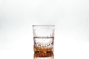 Half full glass on white background. Isolated. Backlight.