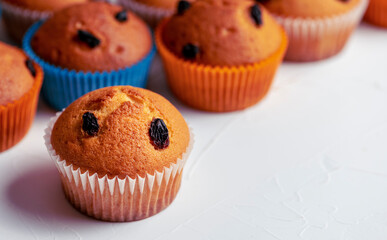 Delicious raisin muffins on table, close-up. Copy space.