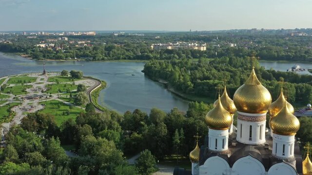 Aerial around view of the Assumption Cathedral in Yaroslavl, park Strelka and Volga river, Russia, 4k