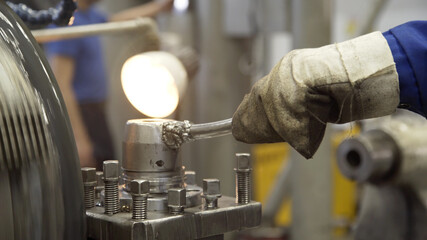 Turning lathe in action. Facing operation of metal blank on turning machine with cutting tool. Old turning lathe machine in turning workshop. Operator machining high precision mold part by cnc lathe