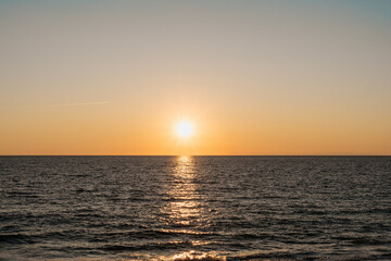 Fototapeta premium Sea at sunset with beautiful reflections, gradient sky on horizon. Touristic destination.