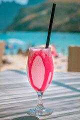 Bright Pink Ice Cold Strawberry Milkshake At An Outdoor Beach Cafe