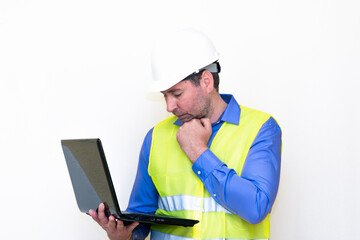 Attractive caucasian Technician Holding Laptop Over White Background.Makes all kinds of grimaces-eyes closed, upset, thinking, shows thumb up, and ok gesture...
