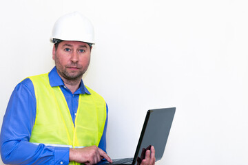 Fototapeta premium Attractive caucasian Technician Holding Laptop Over White Background.Makes all kinds of grimaces-eyes closed, upset, thinking, shows thumb up, and ok gesture...