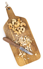 Portion of chopped Cashew nuts isolated on white background (close-up shot)