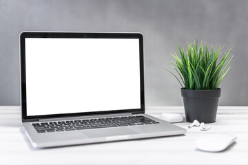 Laptop computer white blank screen on work table front view. Copy space, home and office workspace concept, laptop mockup.
