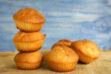 Delicious beautiful cupcakes 
(muffin) of breakfast pastries on a blue wooden background          