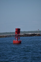 red bouy on breakwater backdrop