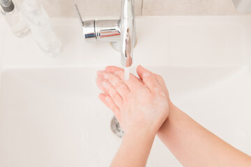 High angle above closeup photo lady wash arms sink under hot water flow stream rub soap bubbles for...