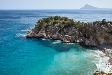 Inlet with turquoise and crystal clear water in Denia, Spain. Concept of vacation and leisure. Long shot.