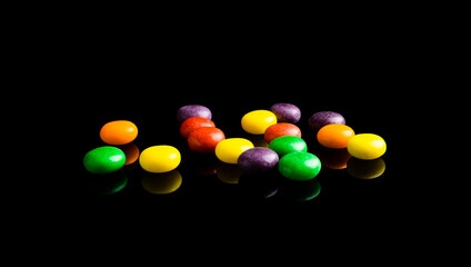 colorful candy on black background