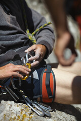 Climber's hands while working with equipment, close-up.