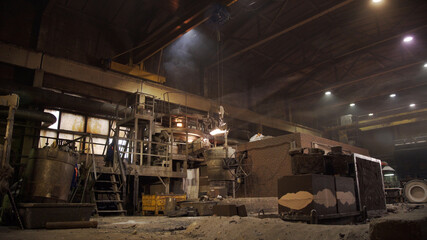 Metal smelting furnace in steel mill. Molten metal pouring, metallurgy, steel casting foundry. Steel manufacturing. Casting shop for gassified models.