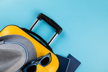 Yellow suitcase with traveler accessories.Travel concept.Holiday Adventure Trip.