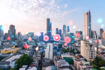 Fototapeta premium Hologram of abstract technology glowing icons, panoramic cityscape of Bangkok at sunset, Asia. The concept of worlds technological changes. Double exposure.