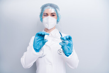Photo of nurse lady doc hold test tube saliva collect equipment examining sick patient wear latex gloves mask coat facial plastic surgical cap isolated grey color background