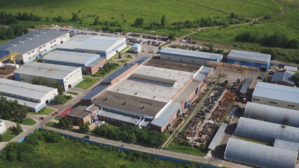 Aerial view park production plant. Manufacturing area in field drone view. Aerial top down view of modern technology manufacturing plant. Aerial footage of building new large industrial complex