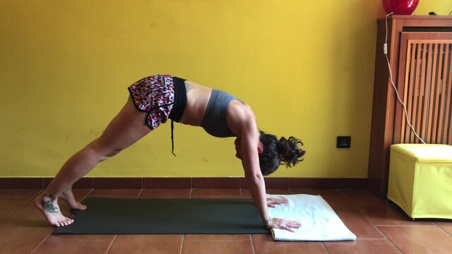 Europe, Italy , Milan - white italian caucasian girl in quarantine home lockdown during COVID10 Coronavirus - lifestyle and activities in apartment  - Jim and yoga relax in the house  