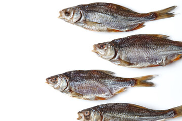Dried or jerky salted roach, palatable clipfish isolated on white background. Salty beer appetizer. Traditional way of preserving fish. Close up
