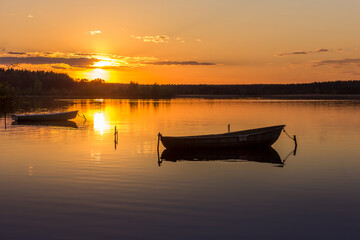 Parking for small fishing boats on the lake during sunset. Beautiful background for cards