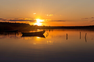 Parking for small fishing boats on the lake during sunset. Beautiful background for cards