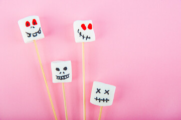 Marshmallows close-up and copy space on a pink background. Marshmallows for Halloween emoticons.