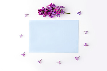 Invitation greeting card. Flat lay flowers composition for your lettering. Frame made of lilac flowers on white background. Top view, copy space for text, mock up. Wedding concept