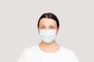 Portrait of a woman adult young in a medical mask on an isolated background