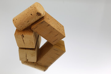 two squares of cork and a stopper, on mirror and white background